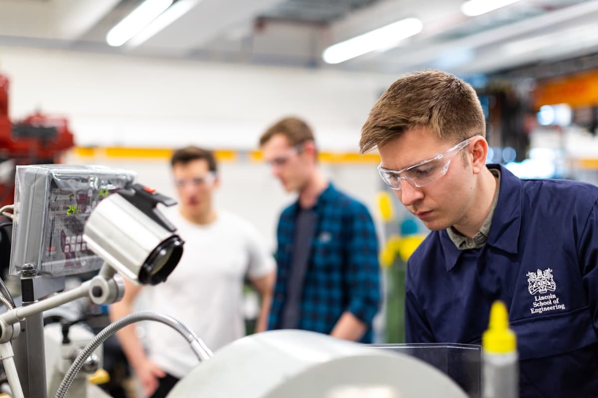 Engineers working with precision equipment in a modern workshop